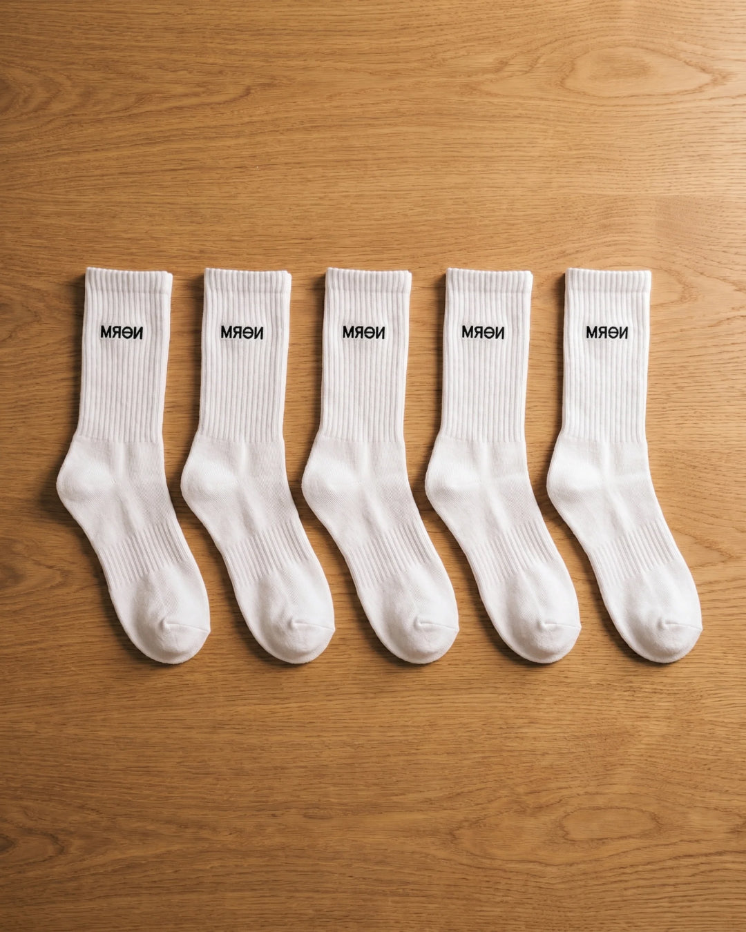 NƟRM Everyday Crew white styled with a neutral shoe, everyday wear, mid-calf shot.