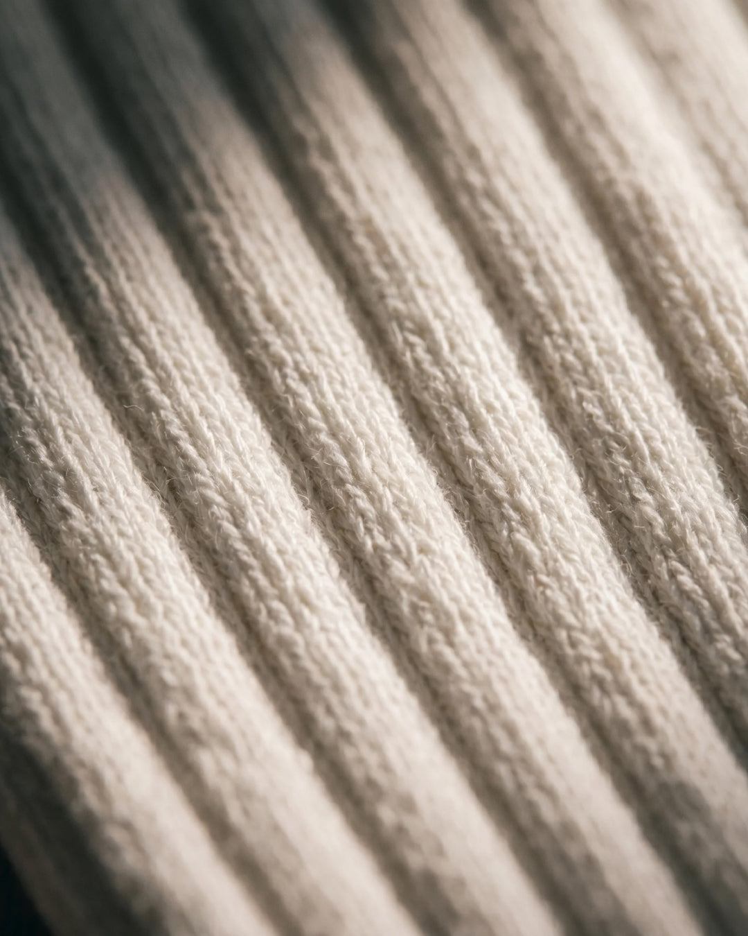 Close-up of the silver-ion knit on NƟRM Everyday Crew white, showing fibre woven into every yarn.