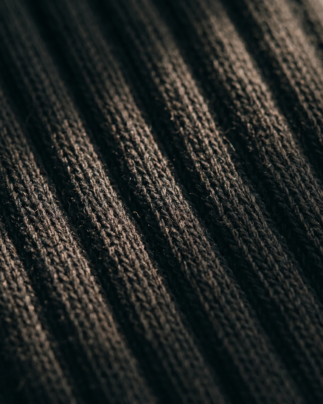 Close-up of the silver-ion knit on NƟRM Everyday Crew black, showing fibre woven into every yarn.