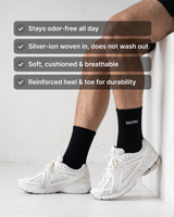 NƟRM Signature Crew in black worn with white sneakers. Stays odor-free all day, silver-ion woven in, soft cushioned and breathable, reinforced heel and toe.