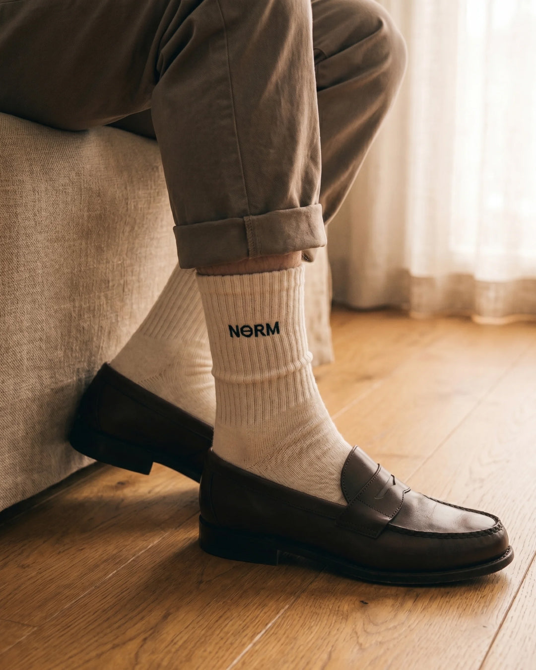 NƟRM Everyday Crew white, worn, second on-foot angle, combed cotton feel.